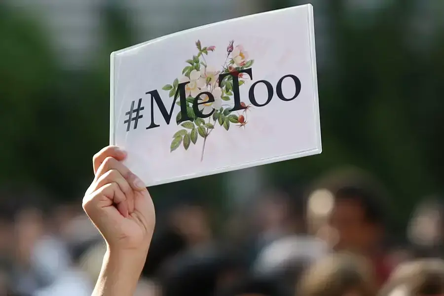 A protester raises a placard reading "#MeToo" during a rally against harassment at Shinjuku shopping and amusement district in Tokyo, Japan, April 28, 2018.