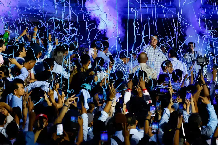 Supporters gather around Presidential candidate Prabowo Subianto as he claims victory after unofficial vote counts during an event to watch the results of the general election in Jakarta, Indonesia, February 14, 2024. 