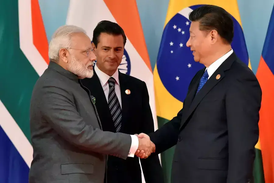 Chinese President Xi Jinping and Indian Prime Minister Narendra Modi shake hands beforethe group photo session of Dialogue of Emerging Market and Developing Countries, in sideline of 2017 BRICS Summit in Xiamen.