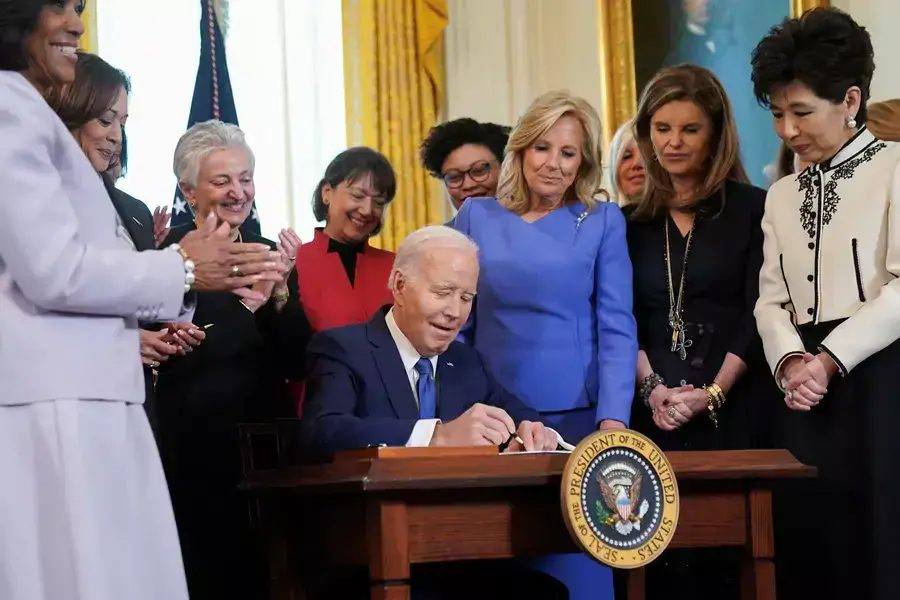Fitst lady Jill Biden and Maria Shriver look on as U.S. President Joe Biden signs an executive order expanding women's healthcare at a ceremony in the White House during Women's History Month