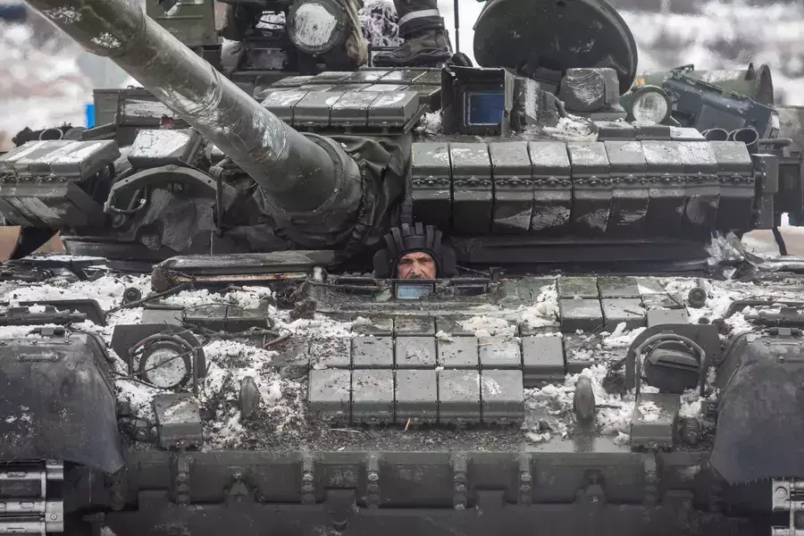 A Ukrainian servicemember drives a tank in the Donetsk region on February 14, 2023.