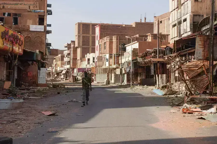 A member of the Sudanese Armed forces walks between damaged buildings, more than one year into the war between the Sudanese Armed Forces and the paramilitary Rapid Support Forces, in Omdurman, Sudan on April 7, 2024.
