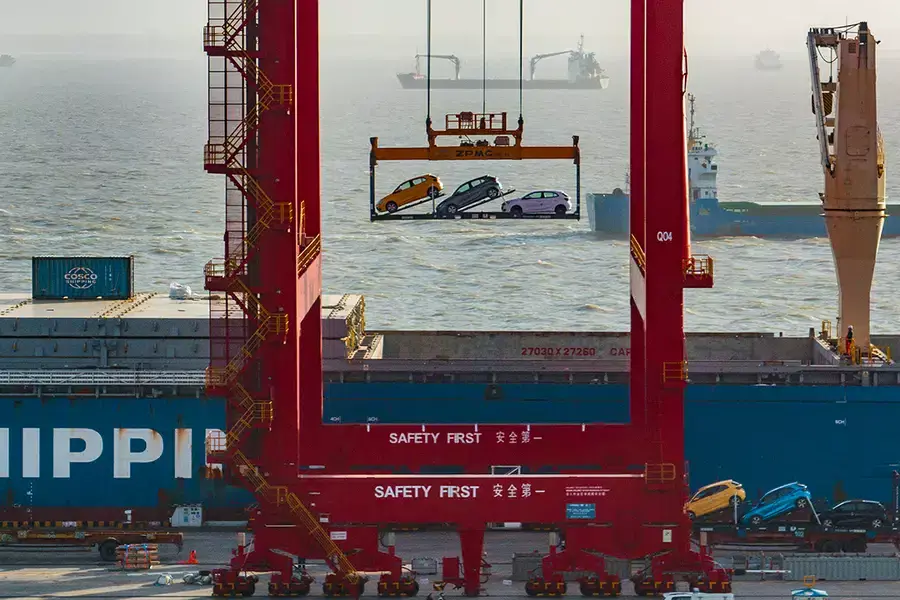 Electric vehicles are loaded onto a container ship in Jiangsu province, China, for export on April 19, 2024.