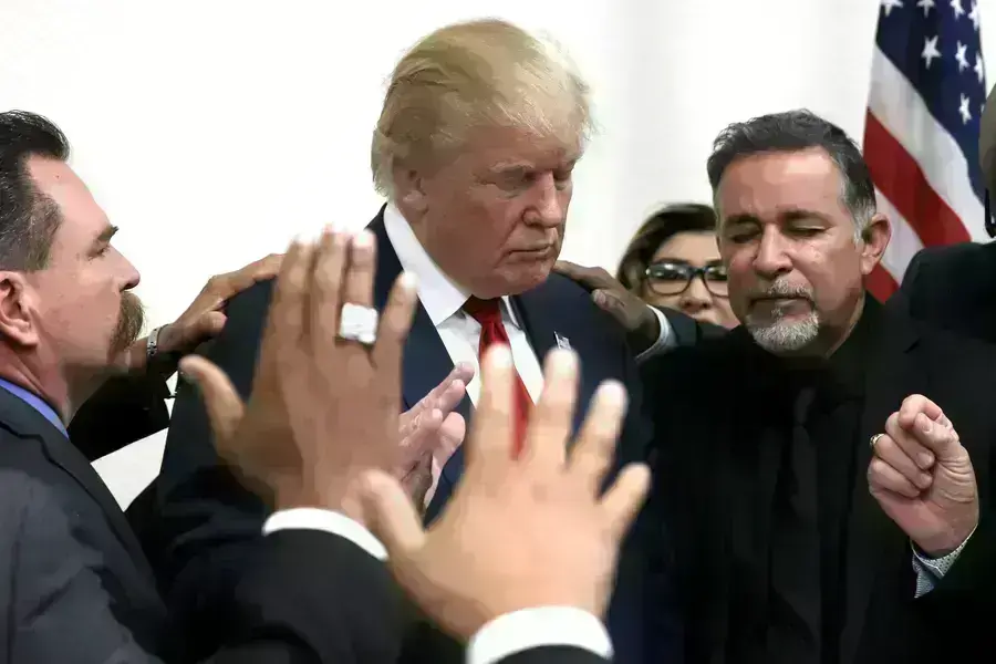 Former U.S. president Donald Trump prays with pastors during a campaign visit to the International Church of Las Vegas and the International Christian Academy in Las Vegas, Nevada, U.S., October 5, 2016.