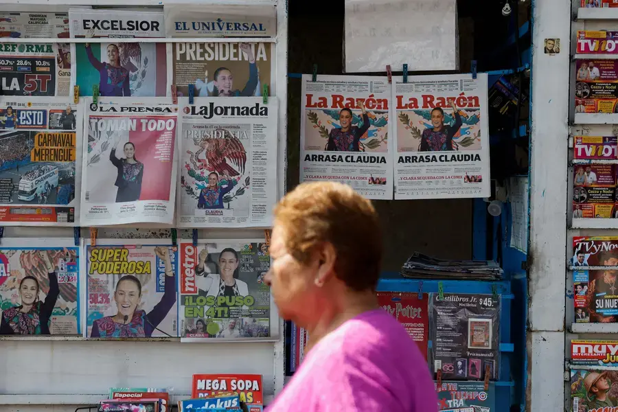 A woman walks past newspapers displaying the victory of the presidential candidate of the ruling Morena party Claudia Sehinbaum, a day after the general election, in Mexico City, Mexico June 3, 2024. 
