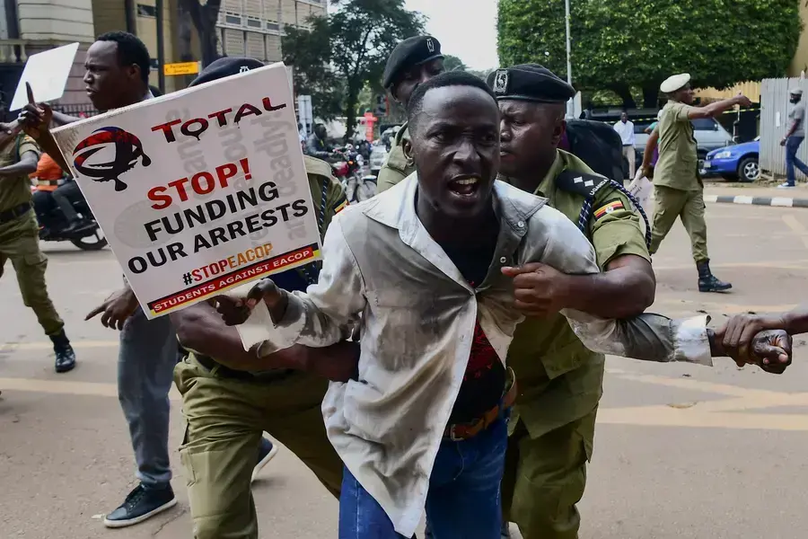 Police officers detain a Ugandan activist participating in a demonstration over proposed plans by Total Energies and the Ugandan government to build the East African Crude Oil Pipeline (EACOP), in Kampala, Uganda on September 15, 2023. 