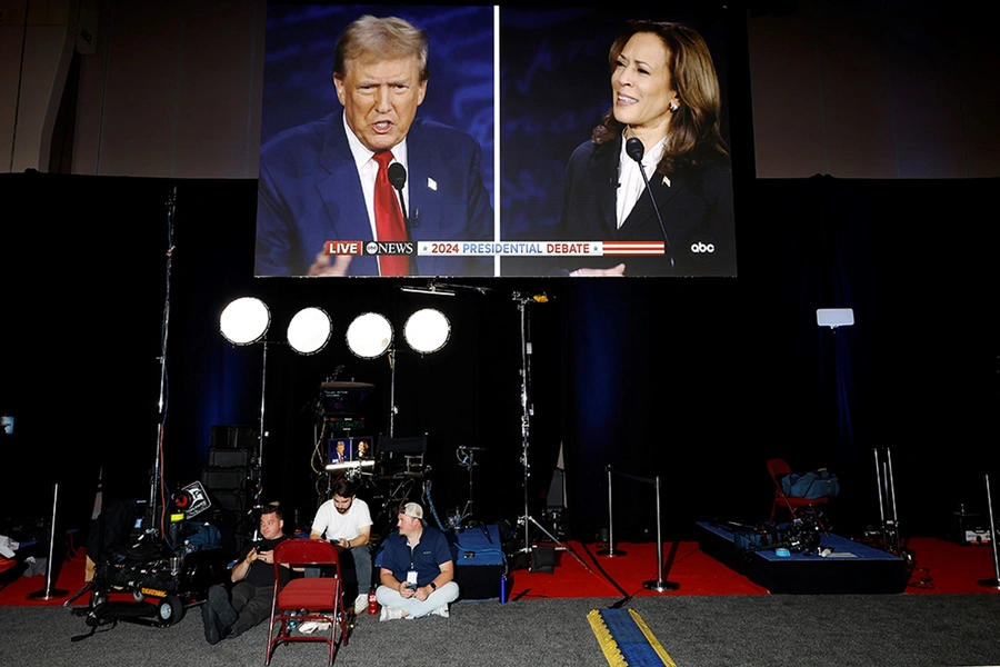 Donald Trump and Kamala Harris are seen on a screen at the Pennsylvania Convention Center on September 10, 2024