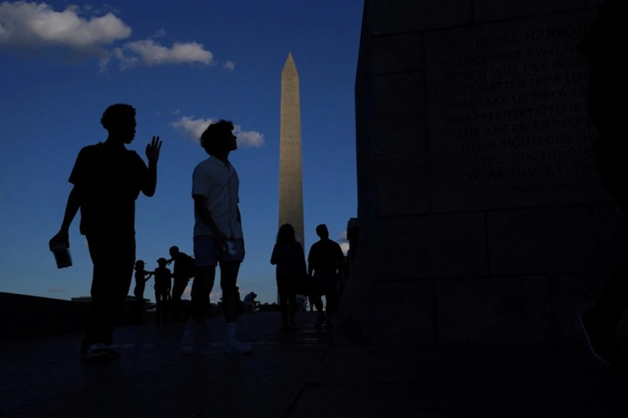 Visitors walk past the Washington Monument in Washington, DC, on Veterans Day, November 11, 2024.