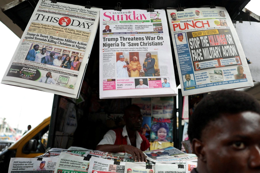 Newspapers with articles reporting U.S. President Donald Trump's message to Nigeria over the treatment of Christians hang at a newspaper stand in Ojuelegba, Lagos, Nigeria, on November 2, 2025.