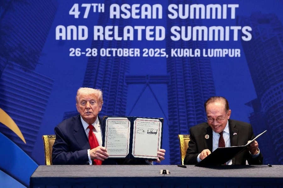 U.S. President Donald Trump and Malaysian Prime Minister Anwar Ibrahim hold up trade deal documents during a bilateral meeting at the 47th Association of Southeast Asian Nations (ASEAN) summit in Kuala Lumpur, Malaysia on October 26, 2025.