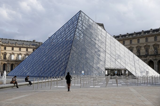 The almost empty courtyard of the Louvre museum and the pyramid of Louvre are seen without tourists on October 14, 2020 in Paris