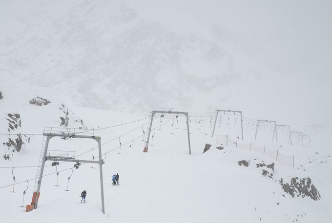 A handful of skiers take their ride empty ski lift at Pitztal glacier, Austria